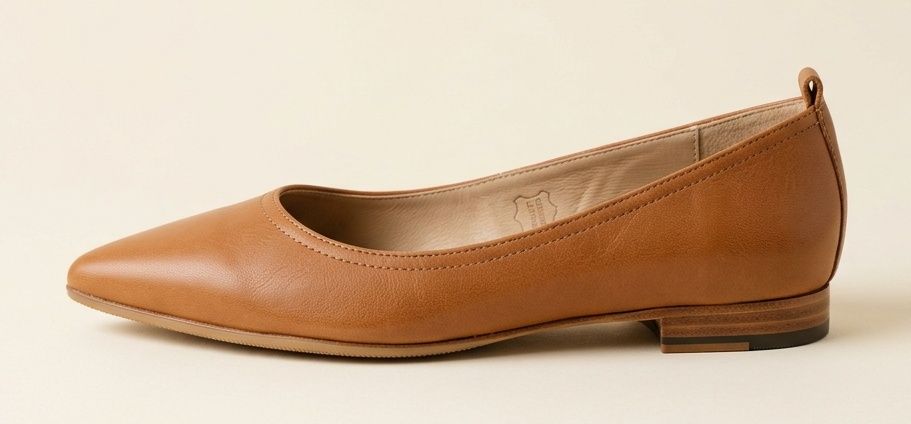 Tan leather pointed flat in side profile